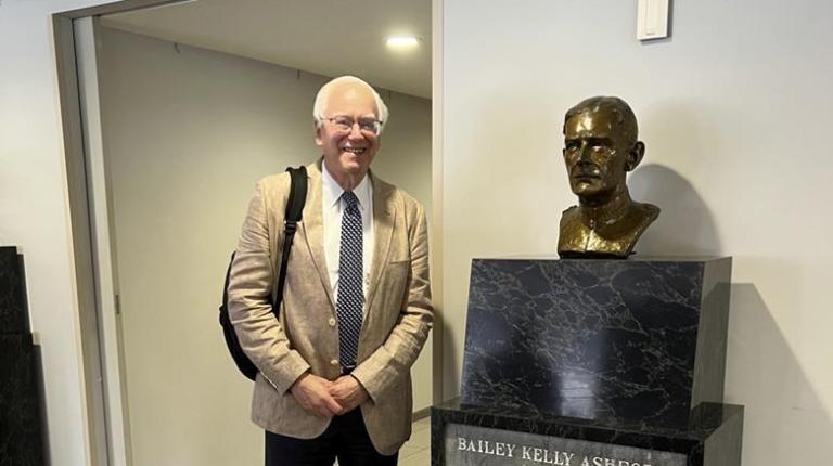Martin Blaser standing next to bust of Bailey Kelly Ashford