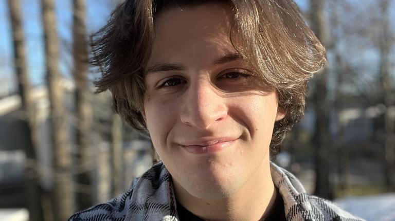 profile photo of Will standing in front of trees