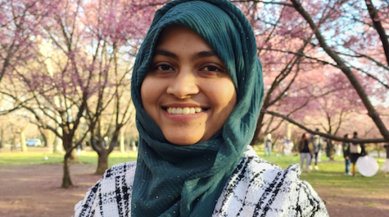 photo of Masuda standing in front of trees