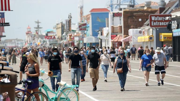 Masked crowds walk along boardwalk in Ocean City, N.J.