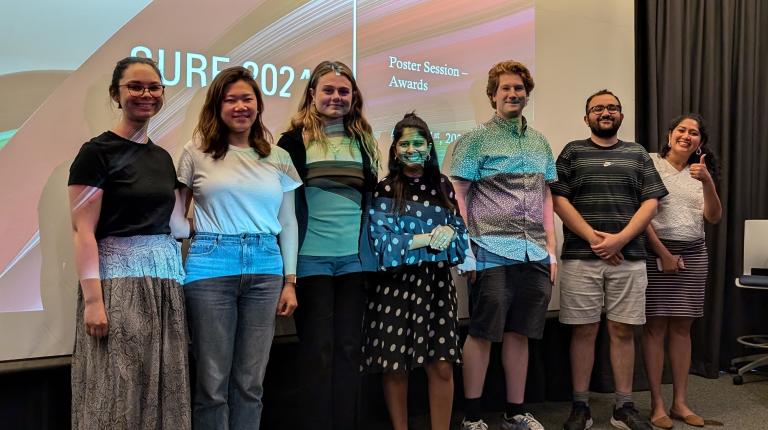 photo of program leaders in front of projector screen