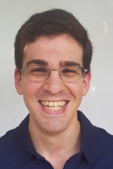 Headshot of Byron wearing blue polo
