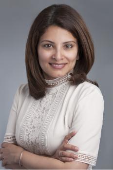 headshot of Chandra in front of grey background