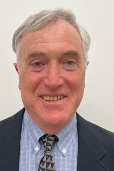 headshot of Charles in front of beige background