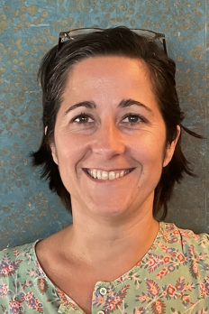 headshot of Claire in front of mosaic background