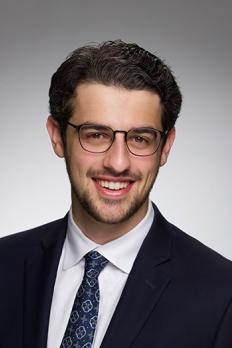 headshot of David in front of grey background