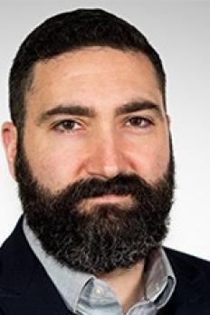 headshot of Doug in front of grey background