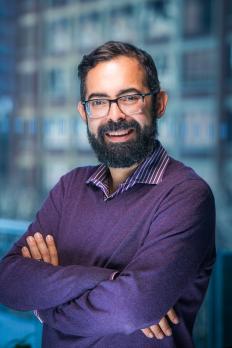 headshot of Edgardo in purple sweater