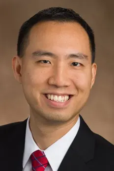 headshot of Ed in front of beige background