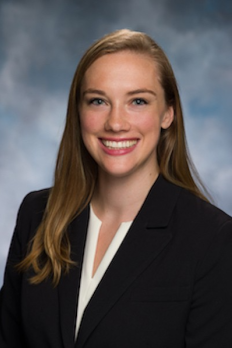 headshot of Erin in front of blue background