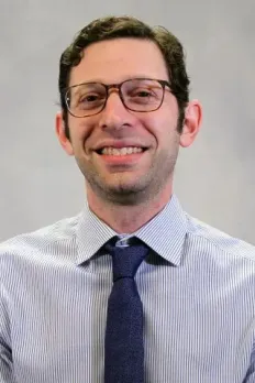 headshot of Henry in front of light grey background