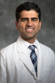 headshot of Jatin in labcoat in front of grey background