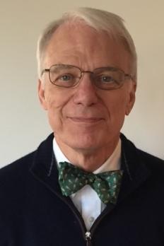 headshot of Jim in front of beige background