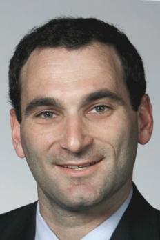 headshot of Josh in front of grey background