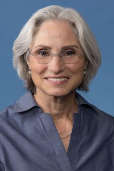 headshot of Karen in front of blue background
