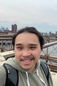 Photo of Michael standing on a bridge