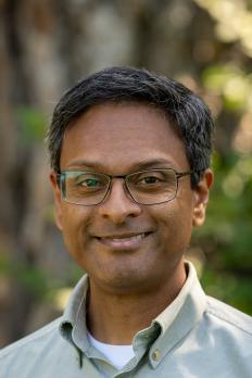 Photo to Niranjan in front of tree