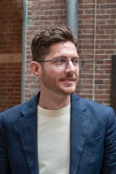 photo of Thomas in front of building