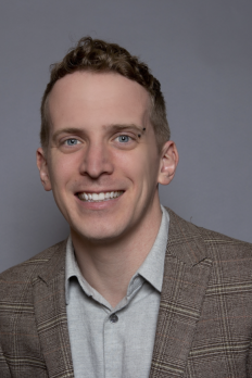 headshot of Tim in front of grey background