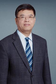photo of Richard in front of blue grey background