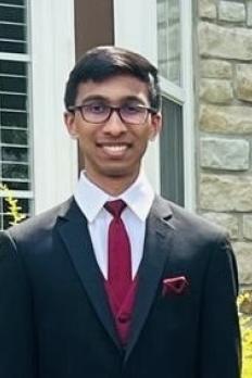 photo of Yash standing in front of window