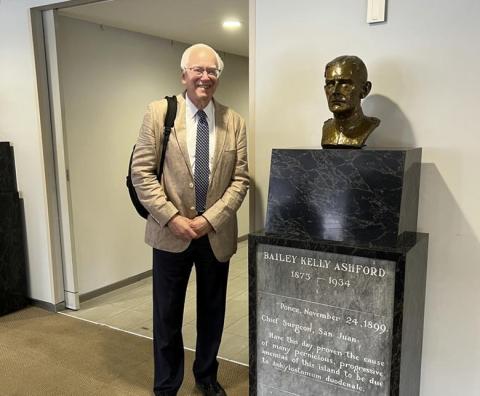 Martin Blaser standing next to bust of Bailey Kelly Ashford