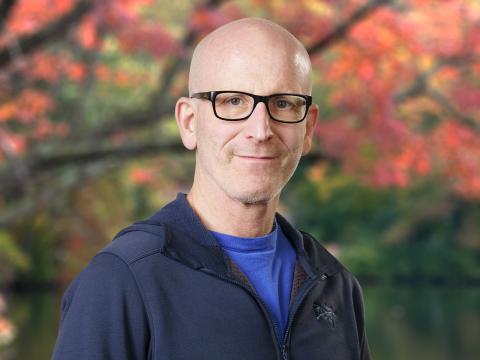 photo of Tony Zador standing in front of tree