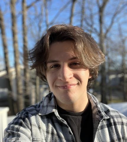 profile photo of Will standing in front of trees