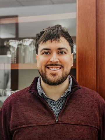 photo of James in maroon quarter zip