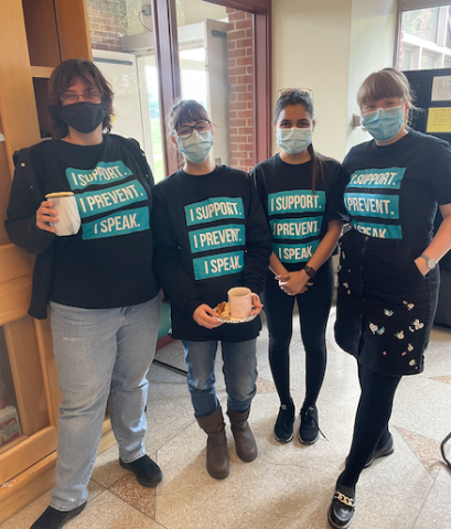CABM members in their teal masks and tshirts