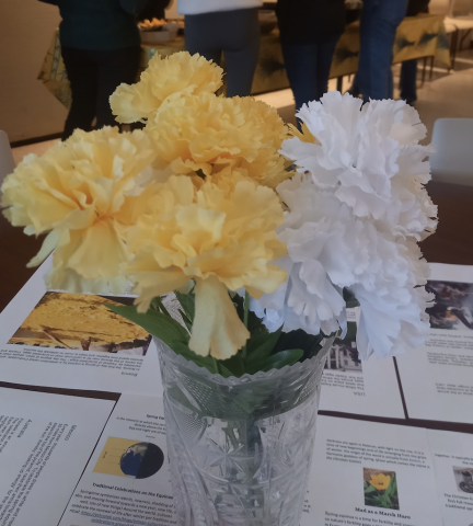 flowers on table with spring equinox literature