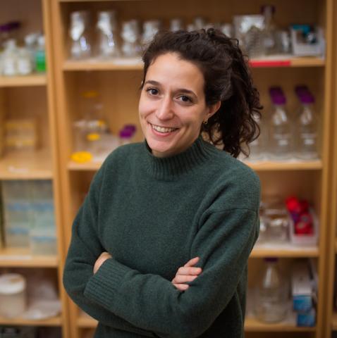 photo of Tami Lieberman in green sweater standing in the lab