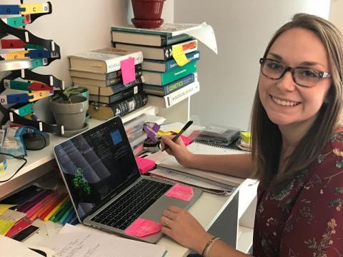 Kelsey sitting at her desk