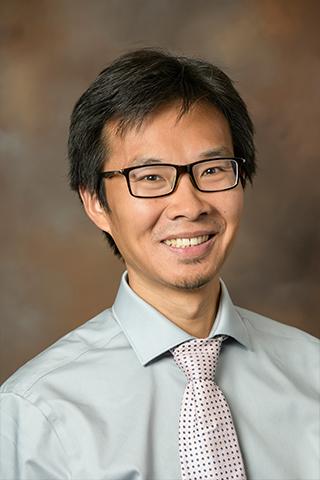 headshot photo of Jun Wang